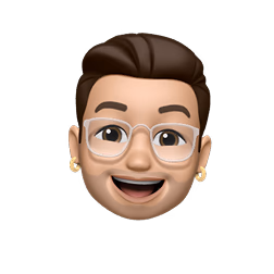 Smiling Memoji with brown hair, glasses, and gold earrings.